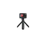 GoPro action camera mounted on a compact tripod against a black background, ready for filming.