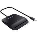 Trust USB-C SD card reader/docking hub in black with a front SD card slot and a small blue LED indicator.
