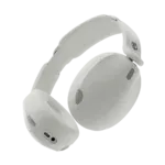 White over-ear headphones shown from a side angle against a black background, with cushioned ear cups and headband visible.