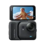 Insta360 GO Ultra compact action camera with a flip-out touchscreen showing a laughing child against a blue sky.