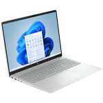 Slim silver laptop opened at an angle, displaying Windows 11 desktop on a light blue background, with a full keyboard and large touchpad