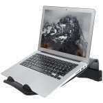 Laptop on a curved ergonomic stand with mountain wallpaper on the screen, shown at an angled workstation.
