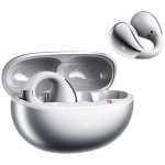White wireless earbuds in an open charging case with a spare ear tip hovering nearby.