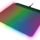 Rainbow RGB-lit gaming laptop shown at an angle, with glowing edge lighting around the chassis and a visible cable plugged in at the back.