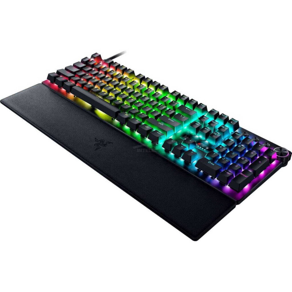 RGB-backlit gaming keyboard with a detachable wrist rest on a white background, showing colorful illuminated keys from blue to red.