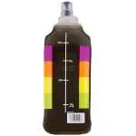 Brown plastic bottle with a white vertical measurement scale on a dark label, flanked by rainbow-colored sticky-note blocks on both sides and a barcode at the bottom.
