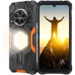 Rugged black smartphone with orange accents and a built‑in back flashlight, front display shows a person on a mountain at sunrise.