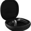 Black true wireless earbuds in an open charging case with lid raised