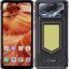 Front and back view of a rugged HOTWAV smartphone with reinforced black casing; home screen shows app icons over a canyon wallpaper, while the rear highlights a triple-camera module and large LED panel on a textured black body.