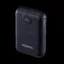 Close-up of a black power bank showing a circular LED reading 100% and USB-C input/output ports on the top edge.