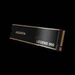 Close-up of a black ADATA Legend 900 SSD with gold edges, partially visible at the bottom left against a black background.