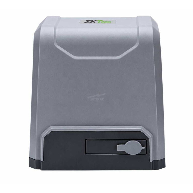 Gray compact safe with a black base and a round key lock on the front-right area. The top shows a small label, suggesting a secure storage unit.