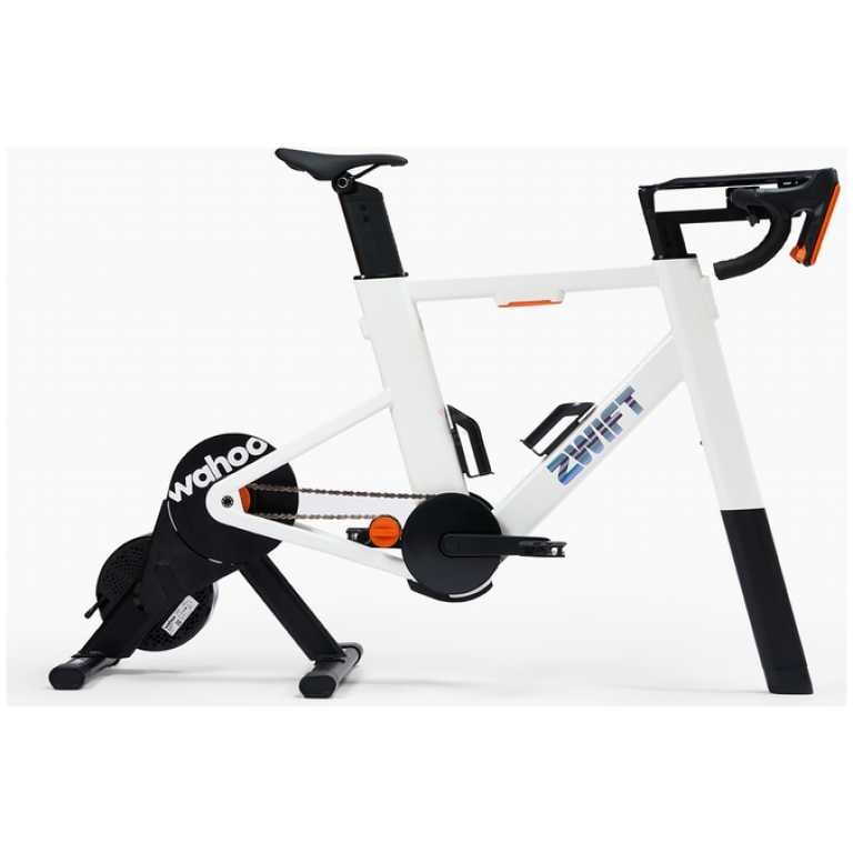 White indoor bike trainer setup with a road bike mounted, black rear flywheel labeled Wahoo and orange accents.