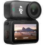 Compact action camera with a top-mounted lens and a rear touchscreen showing a desert landscape video.