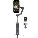 DJI handheld smartphone gimbal with phone mounted, showing stabilizing arm and tripod base with accessories nearby